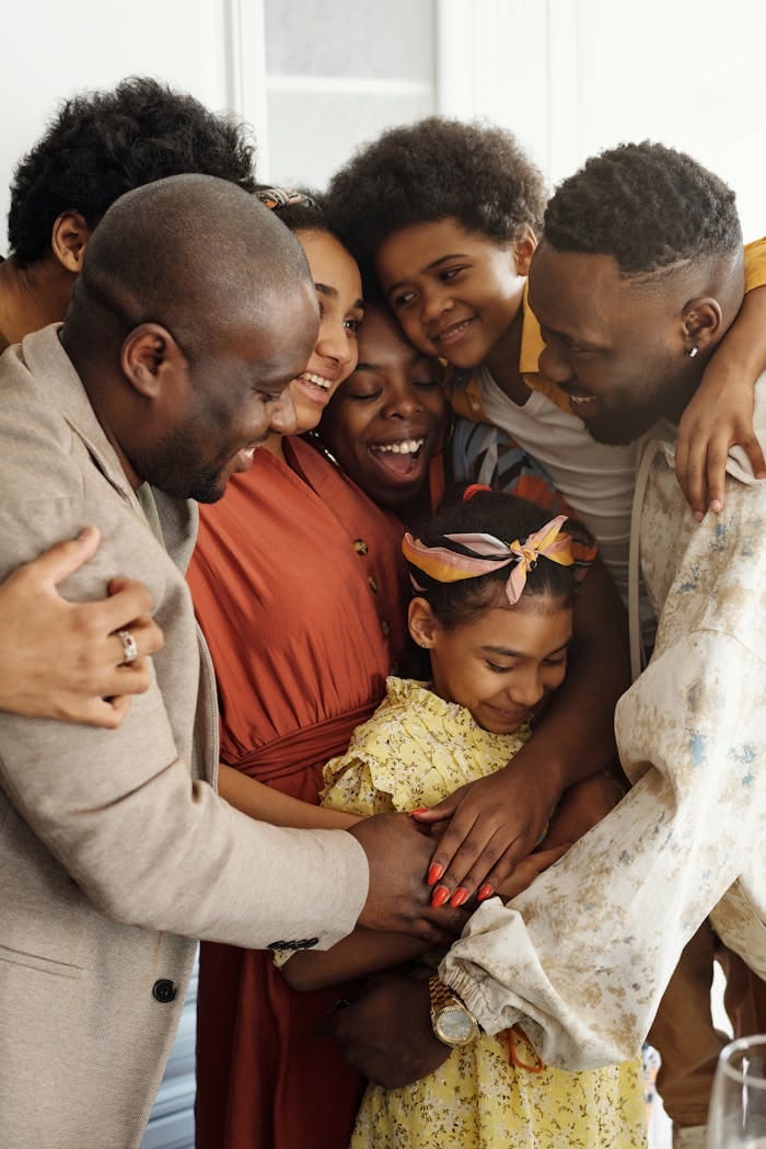 missions-01 Heartwarming family group hug showcasing affection and togetherness indoors.